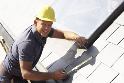 Roofer Working On Exterior Of New Home