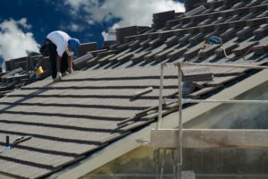Roofer laying tile